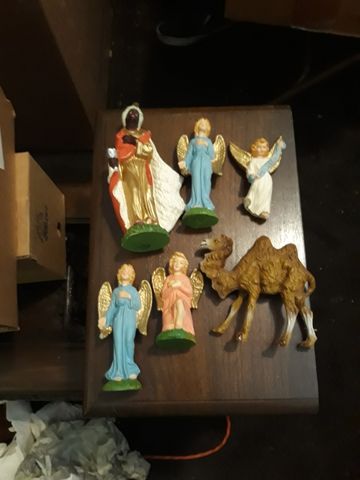 Nativity figurines including wise men, an angel, and a camel